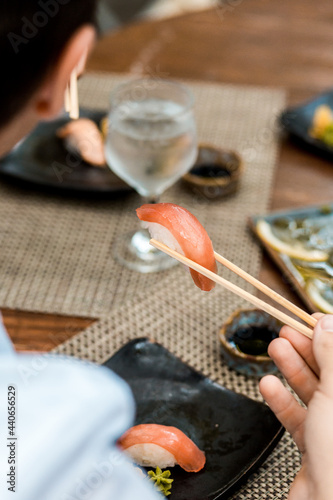 Delicious Sushi Menu Food Sashimi Salmon Tuna Shrimp Hashi Holds Gourmet Plate Restaurant Wooden Table