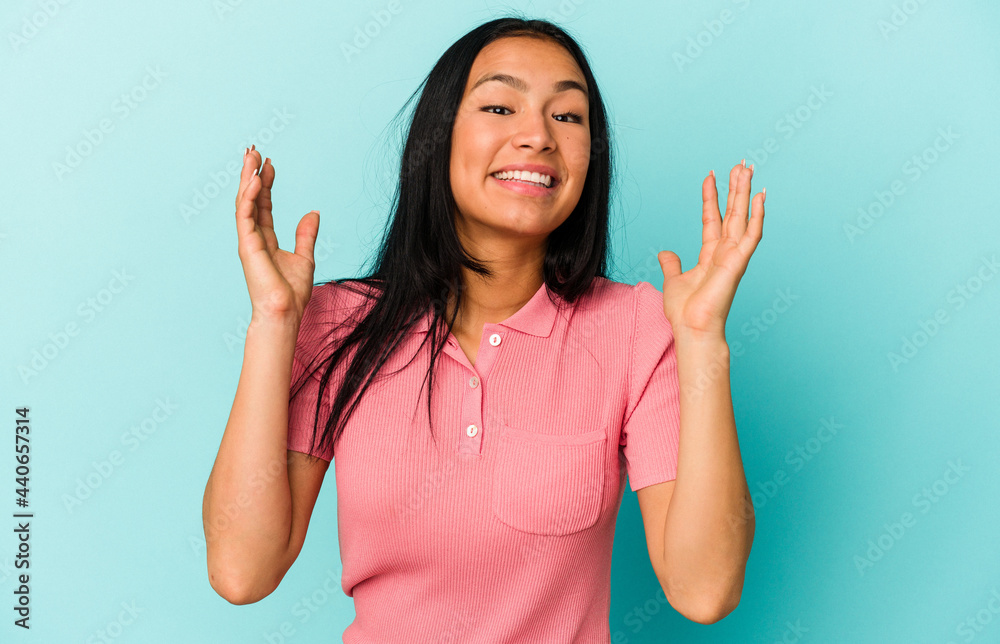 Young Venezuelan woman isolated on blue background laughs out loudly keeping hand on chest. Young Venezuelan woman isolated on blue background laughs out loudly keeping hand on chest.