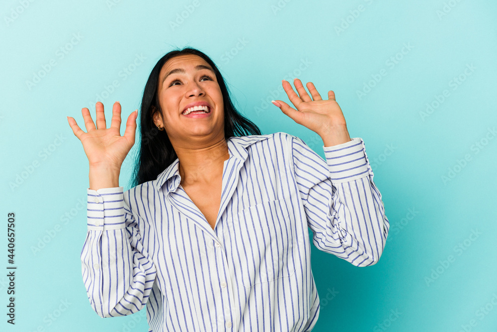 Young Venezuelan woman isolated on blue background screaming to the sky, looking up, frustrated. Young Venezuelan woman isolated on blue background screaming to the sky, looking up, frustrated.