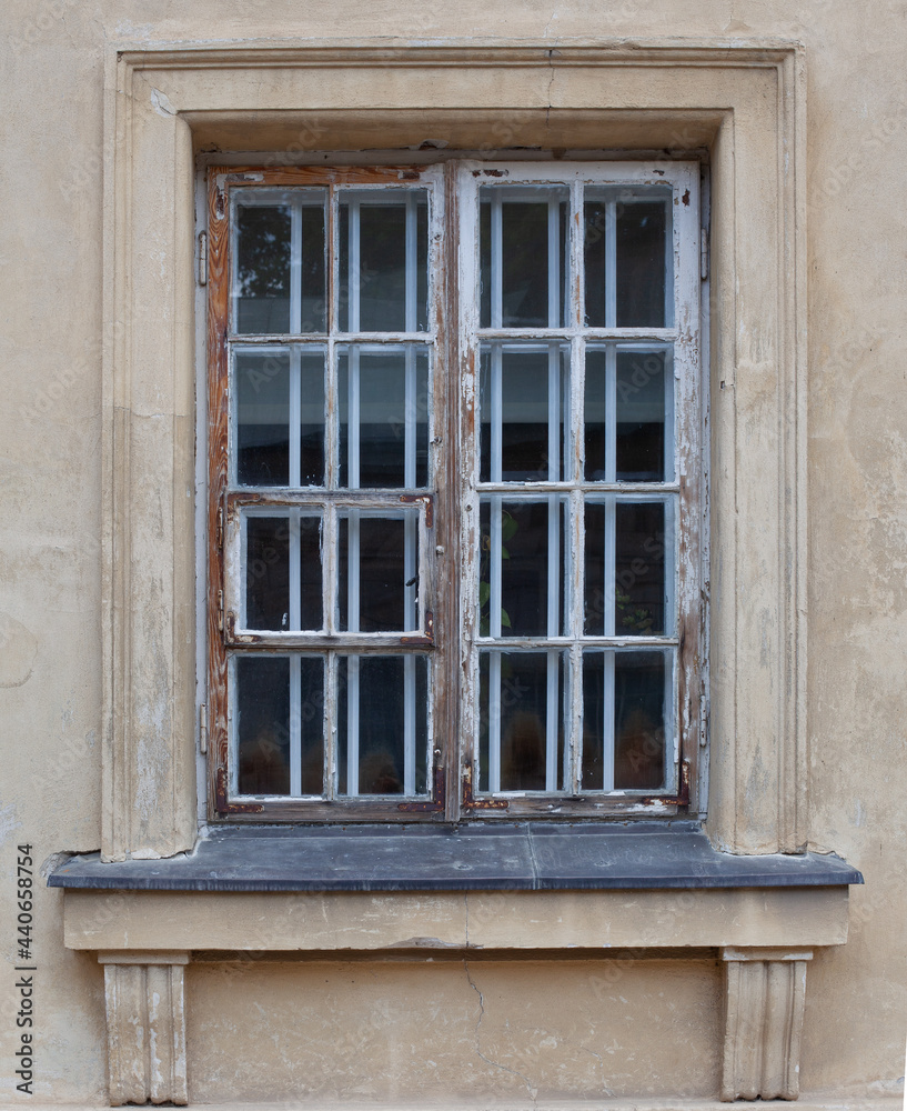 Old and beautiful antique, damaged window. Sophisticated facade, detail