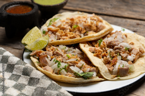 Pork carnitas tacos on wooden background. Mexican food