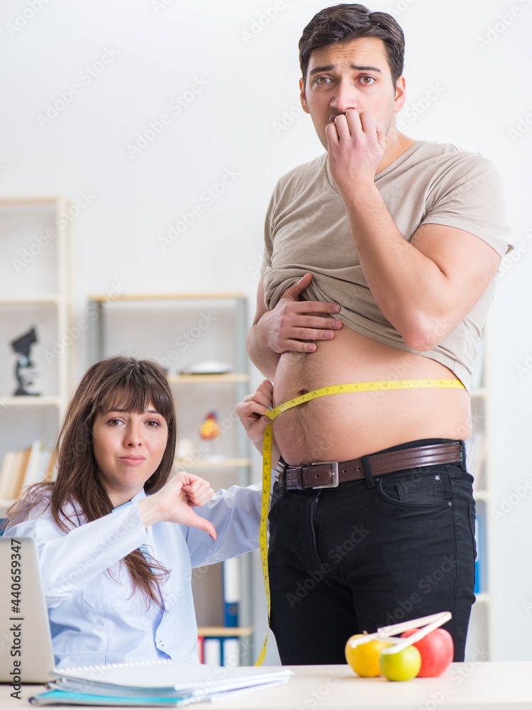 Doctor dietician giving advices to fat overweight patient Doctor dietician giving advices to fat overweight patient
