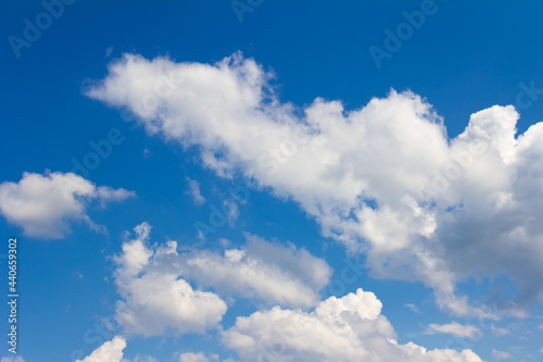 Blue sky with white and gray clouds. Bright sunny cloudscape 