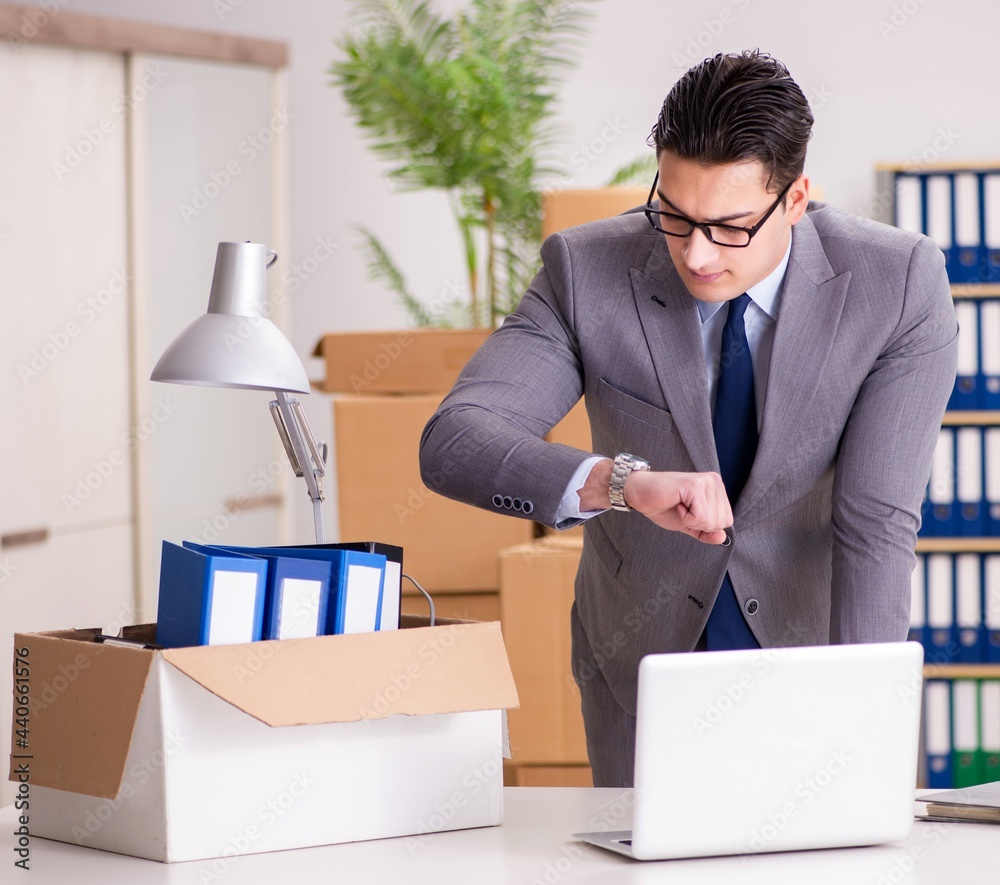 Young handsome businessman moving offices