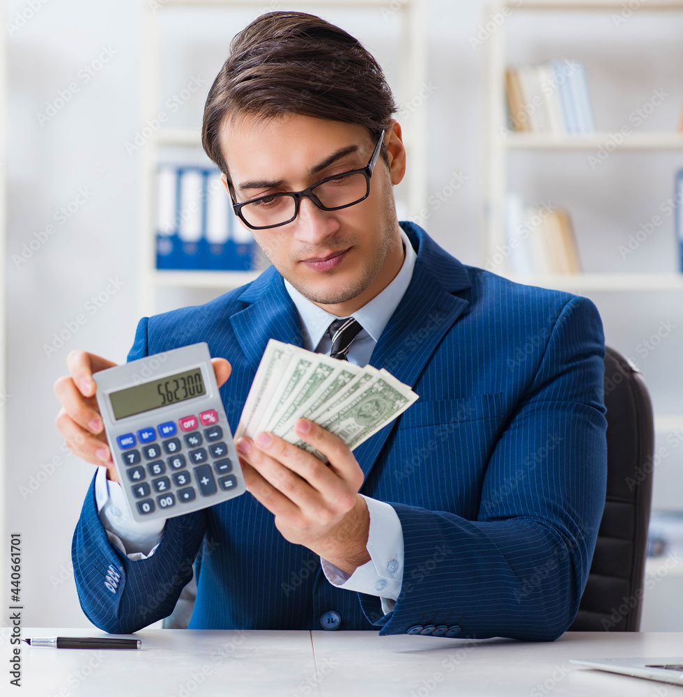 Accountant calculating dollars with calculator in office Accountant calculating dollars with calculator in office