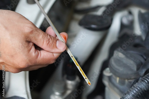 convertible car mechanic check engine oil mechanic's side view Also check the oil level in the car. Special tool, male hand, with a durable automotive engine oil dipstick. for safety for travel