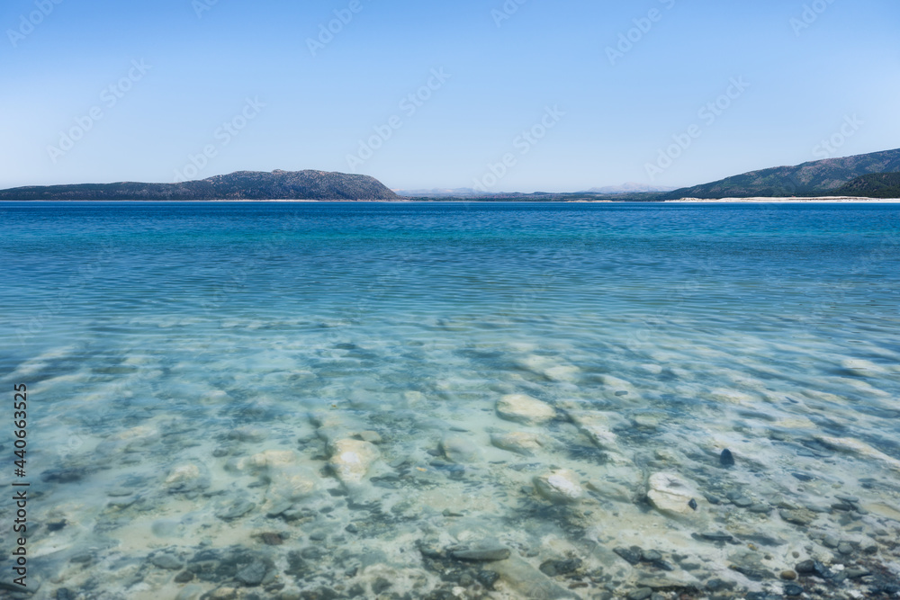 Lake Salda, Turkey. A popular place for recreation and tourism. White sand and blue water. Natural background. Lake Salda, Turkey. A popular place for recreation and tourism. White sand and blue water. Natural background.