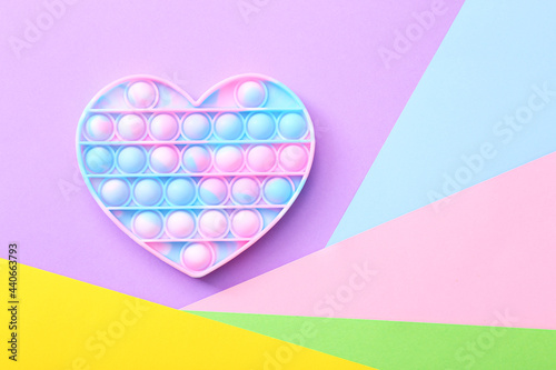Cuadro en lienzo Trendy toy antistress, pop it on a colorful background, fidget toy, top view