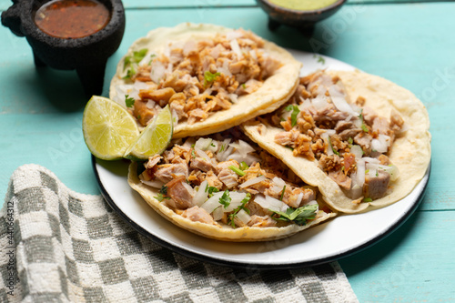 Carnitas tacos on turquoise background. Mexican food