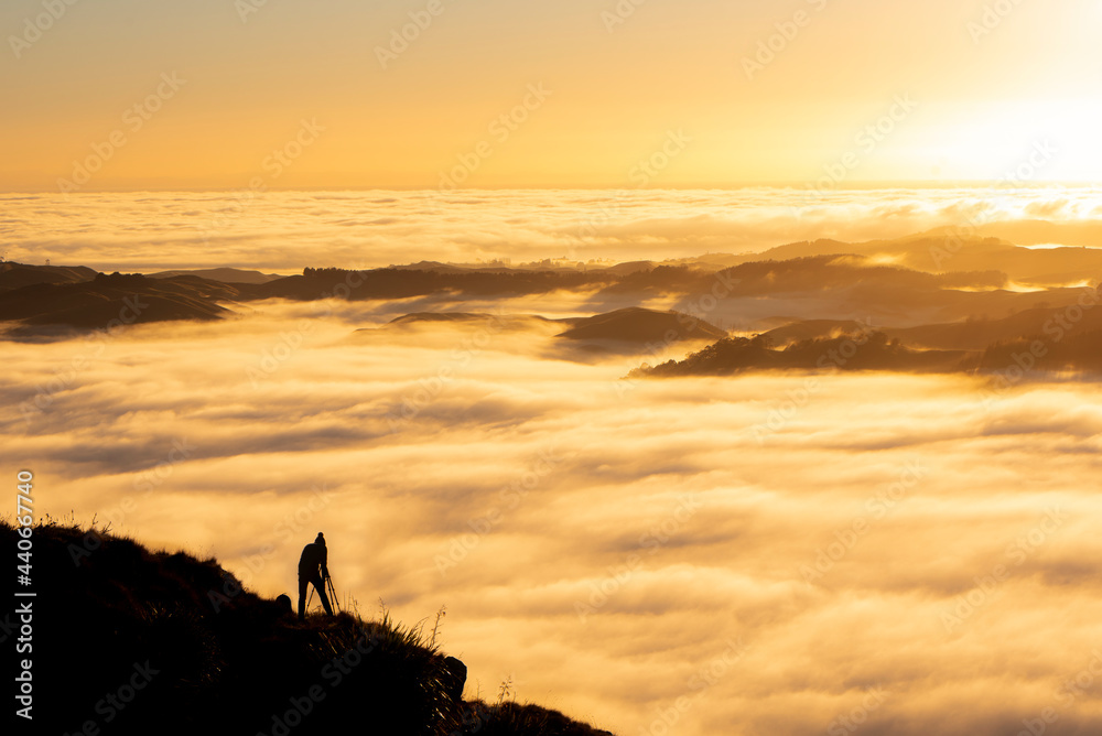 Landscape Photographer taking pictures of sunrise and morning fog at Te Mata Peak, Hawke's Bay, New Zealand