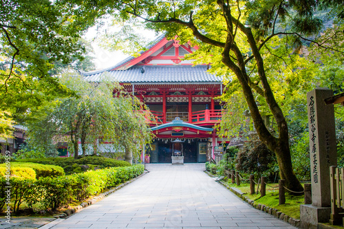 Buddhist temple, in red color, splendorous among the green trees, located in the Natadera, one of the oldest temple complexes in Japan, close to 1300 years old.