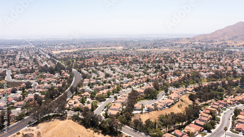 Daytime aerial view of a suburban neighborhood in Moreno Valley, California, USA. © Matt Gush