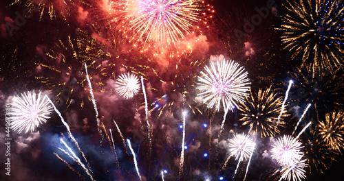 Colorful vibrant Firework celebrate anniversary happy new year 2022, 4th of july holiday festival. colorful firework in the night time to celebrate national holiday. countdown new year 2022 party time
