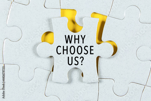 Why Choose Us text on a Jigsaw Puzzle - business concept