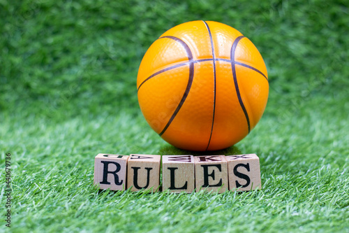 Basketball is on green grass with word RULES