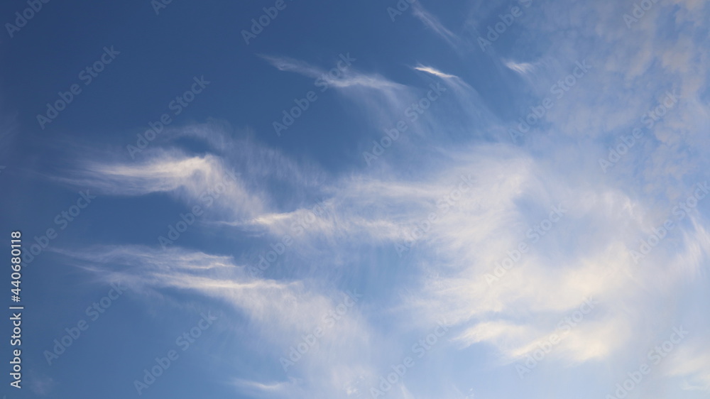 White clouds in the blue sky. The streaks of clouds are strangely beautiful on a clear day. Selective focus