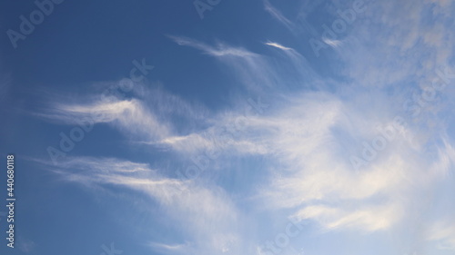 White clouds in the blue sky. The streaks of clouds are strangely beautiful on a clear day. Selective focus