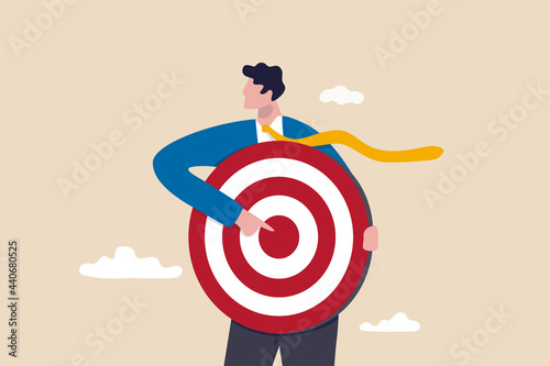 Focus on business target, setting goal for motivation, target audience for advertising or purpose for career development concept, businessman holding archer target or dashboard pointing at bullseye.