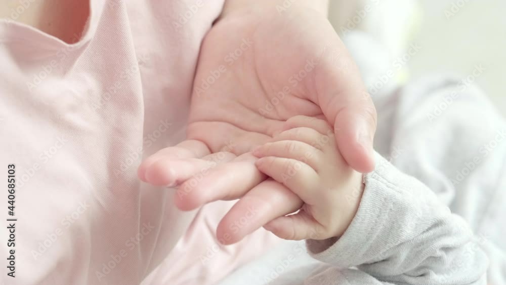 4k Newborn Baby Hand Holding Mother, Mom touching baby tiny hand to make him feeling her love, warm and secure. Maternity, family, birth concept. 4k Newborn Baby Hand Holding Mother, Mom touching baby tiny hand to make him feeling her love, warm and secure. Maternity, family, birth concept.