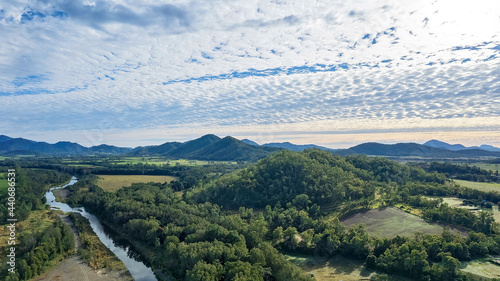 Creek Ecosystem Through Forest Country Under Striking Clouds photo