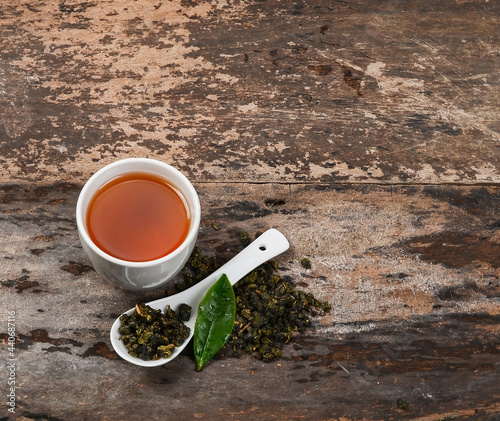 Tae cup and dry leaf on a background