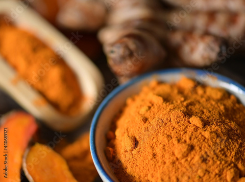turmeric and turmaric powder on wooden background.