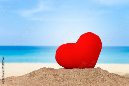 Red heart on the beach, love and romance concept, valentine card idea