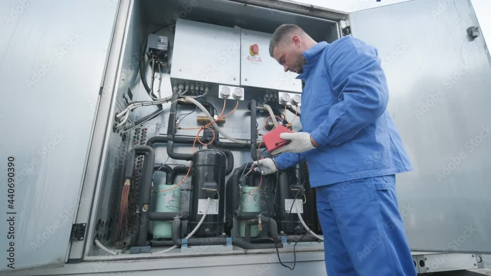 The technician repair electronic temperature sensors with an electronic soldering iron