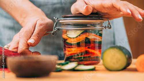 Cuadro en lienzo Woman Holding a Jar with Fermented Vegetables.