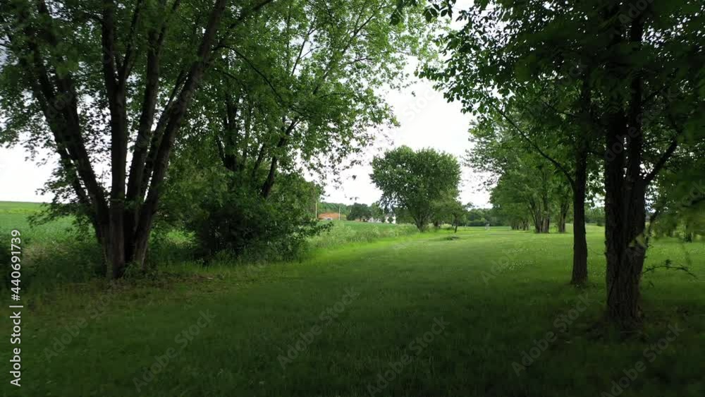 Hole number 5. Shot from tee pad, past trees to basket at Lancaster Bible College disc golf course. Series available. Hole number 5. Shot from tee pad, past trees to basket at Lancaster Bible College disc golf course. Series available.
