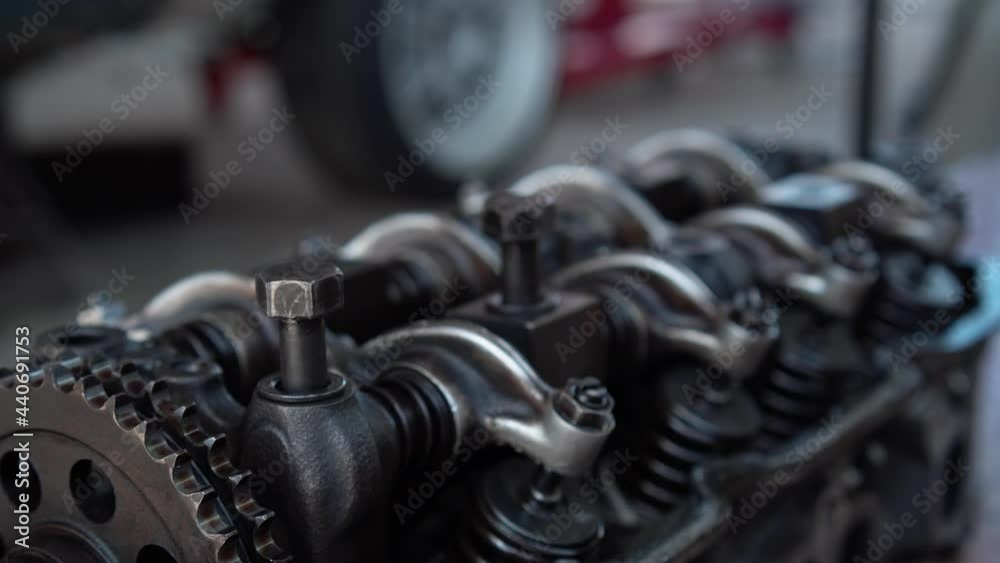 Close up of Auto mechanic overhaul car engine, Car mechanic repairs vehicle in a workshop, Repair and maintenance service concepts Close up of Auto mechanic overhaul car engine, Car mechanic repairs vehicle in a workshop, Repair and maintenance service concepts
