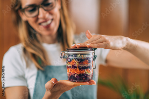 Woman Holding a Jar with Fermented Vegetables.