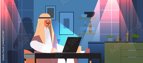 arab businessman freelancer looking at laptop screen arabic man sitting at workplace in dark night home room