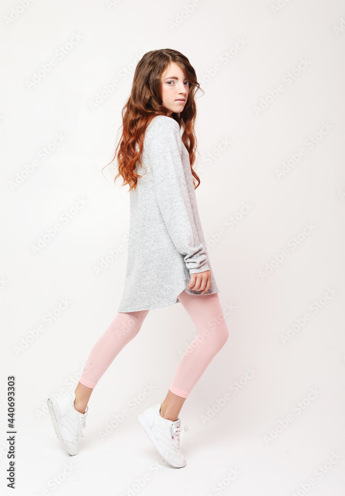 little girl with long curly hair dressed casually posing on white background little girl with long curly hair dressed casually posing on white background