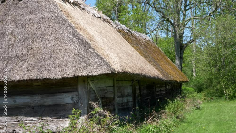 Close Up Of A Traditional Barn House With Thatched Roof At Countryside In Halland, Sweden. Slider right Close Up Of A Traditional Barn House With Thatched Roof At Countryside In Halland, Sweden. Slider right