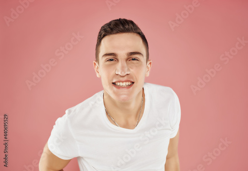 smiling man in white t-shirt pink background close-up pink background emotions © SHOTPRIME STUDIO