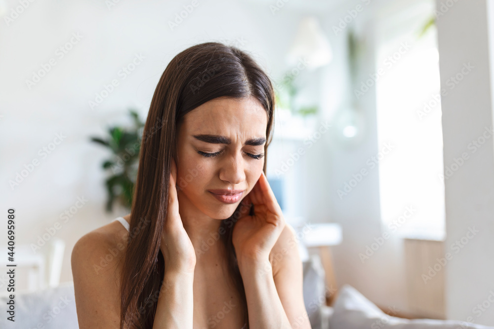 Portrait of unhappy caucasian woman suffering from toothache at home. Healthcare, dental health and problem concept. Stock photo