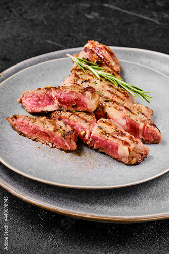 Closeup view of ribeye steak on a plate.