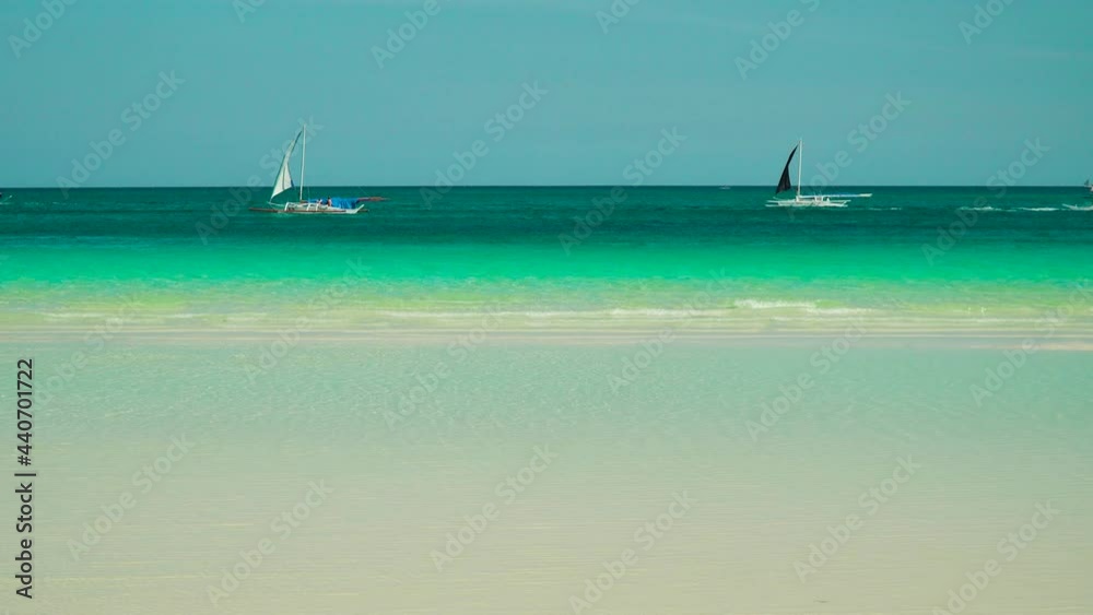 Sandy tropical beach with boats and yachts and blue sea gainst the sky. Summer and travel vacation concept. Sandy tropical beach with boats and yachts and blue sea gainst the sky. Summer and travel vacation concept.