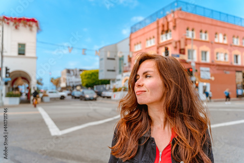 Young woman on the street with a blue sky on Venice Beach and the famous inscription, Los Angeles © KseniaJoyg