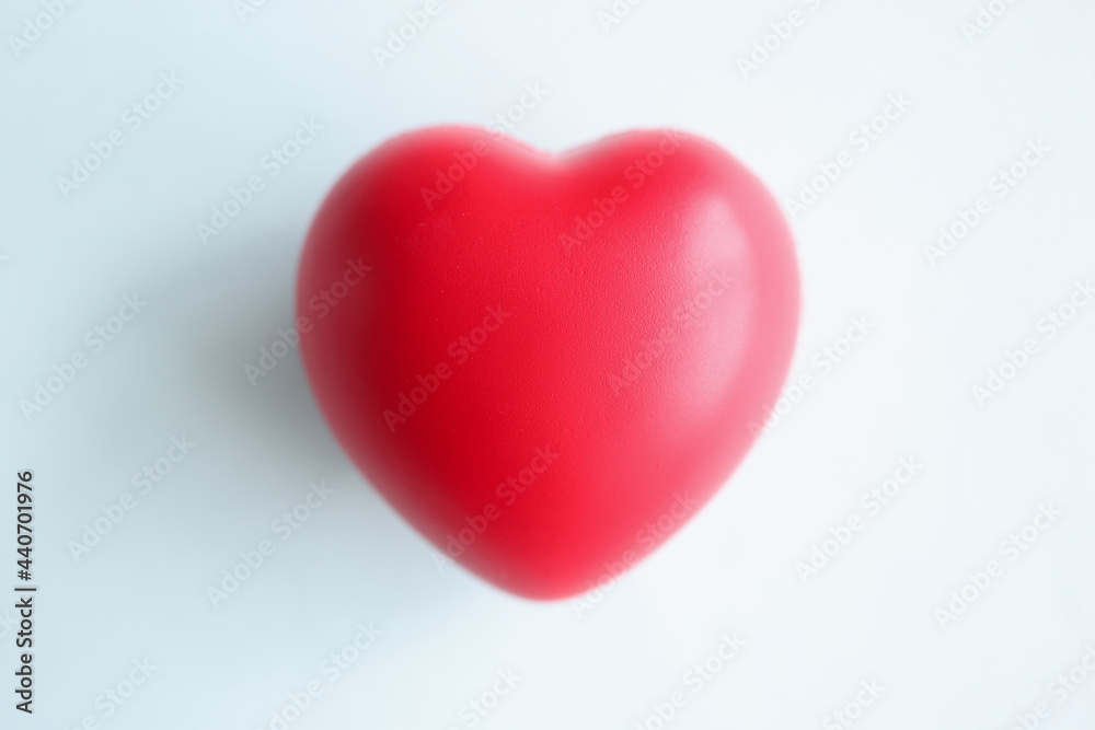 Small red heart on blue blurred background