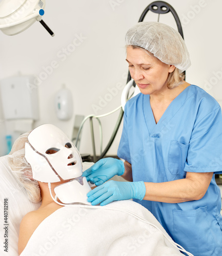 Adult girl expects plastic surgery in aesthetic cosmetology clinic