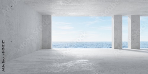 Obraz na plátne Abstract empty, modern concrete room with opening with ocean view in the back wa