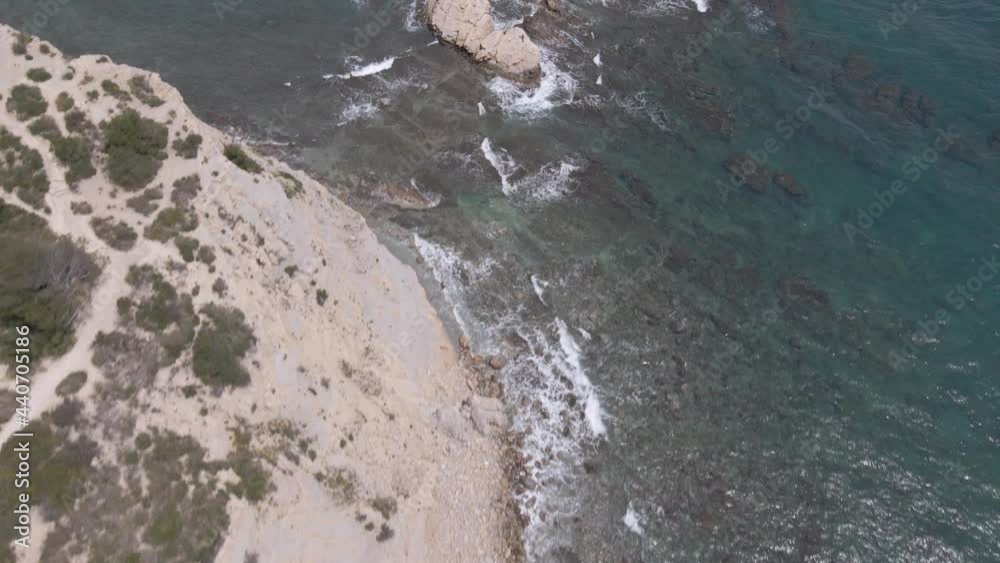 Coastal trail overlooking Mediterranean Sea, waves washing on rocks, Cape Prim, Javea. Coastal trail overlooking Mediterranean Sea, waves washing on rocks, Cape Prim, Javea.