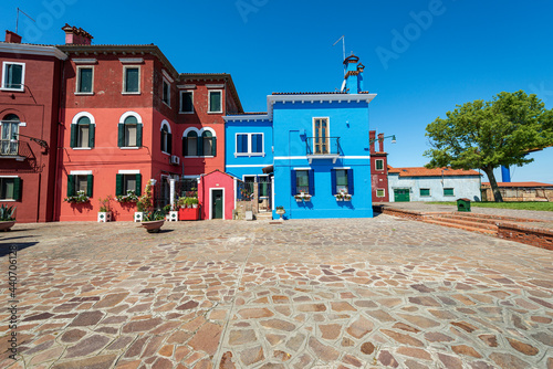 Old small multi colored houses (bright colors) in Burano island in a sunny spring day. Venetian lagoon, Venice, UNESCO world heritage site, Veneto, Italy, southern Europe. © Alberto Masnovo