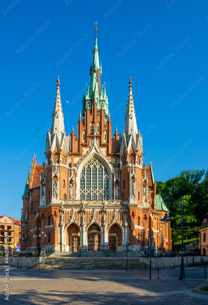 Krakow, Poland. Church Saint Joseph - a historic Roman Catholic church in Gothic Revival (neo-Gothic) style at the Podgorski Square in Podgorze district in Cracow in sunset light
