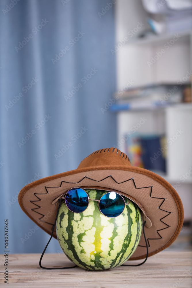 Watermelon wearing sunglasses and cowboy hat