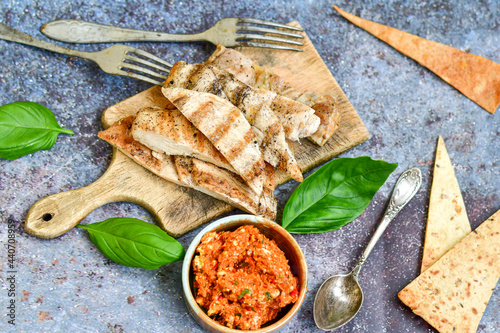 Grilled chicken fillets with  olive oil, chili pepper,   and tomato paste 