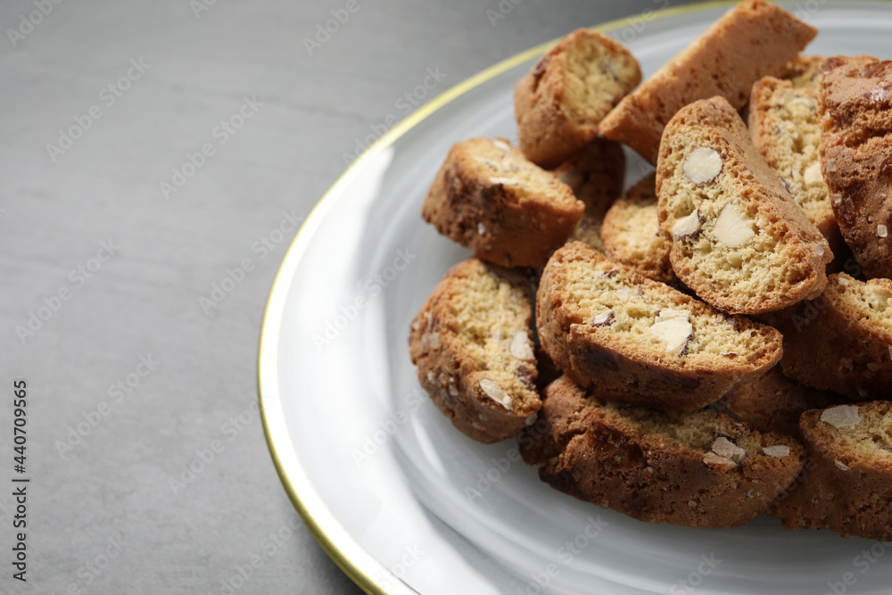 Traditional Italian almond biscuits (Cantucci) on grey table, closeup Traditional Italian almond biscuits (Cantucci) on grey table, closeup