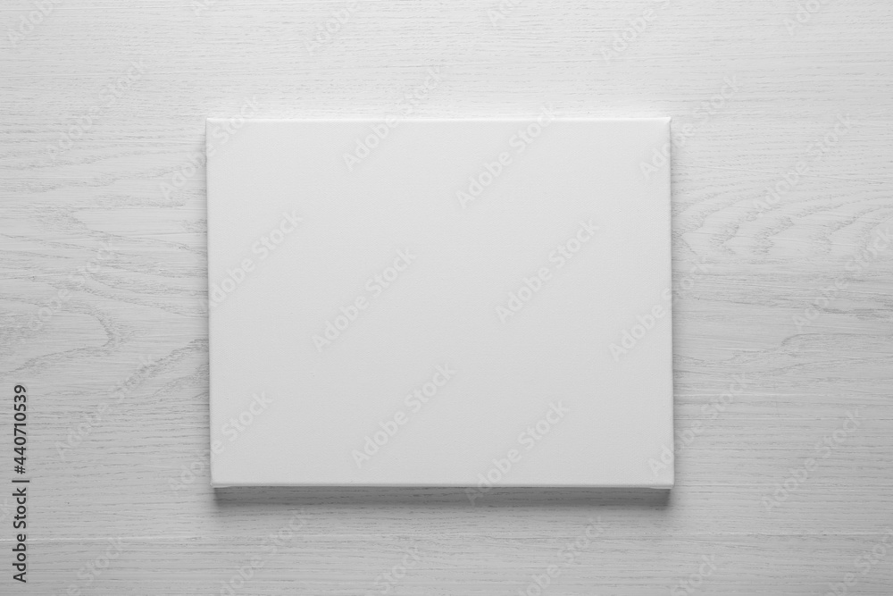 Blank canvas on white wooden background, space for text Blank canvas on white wooden background, space for text